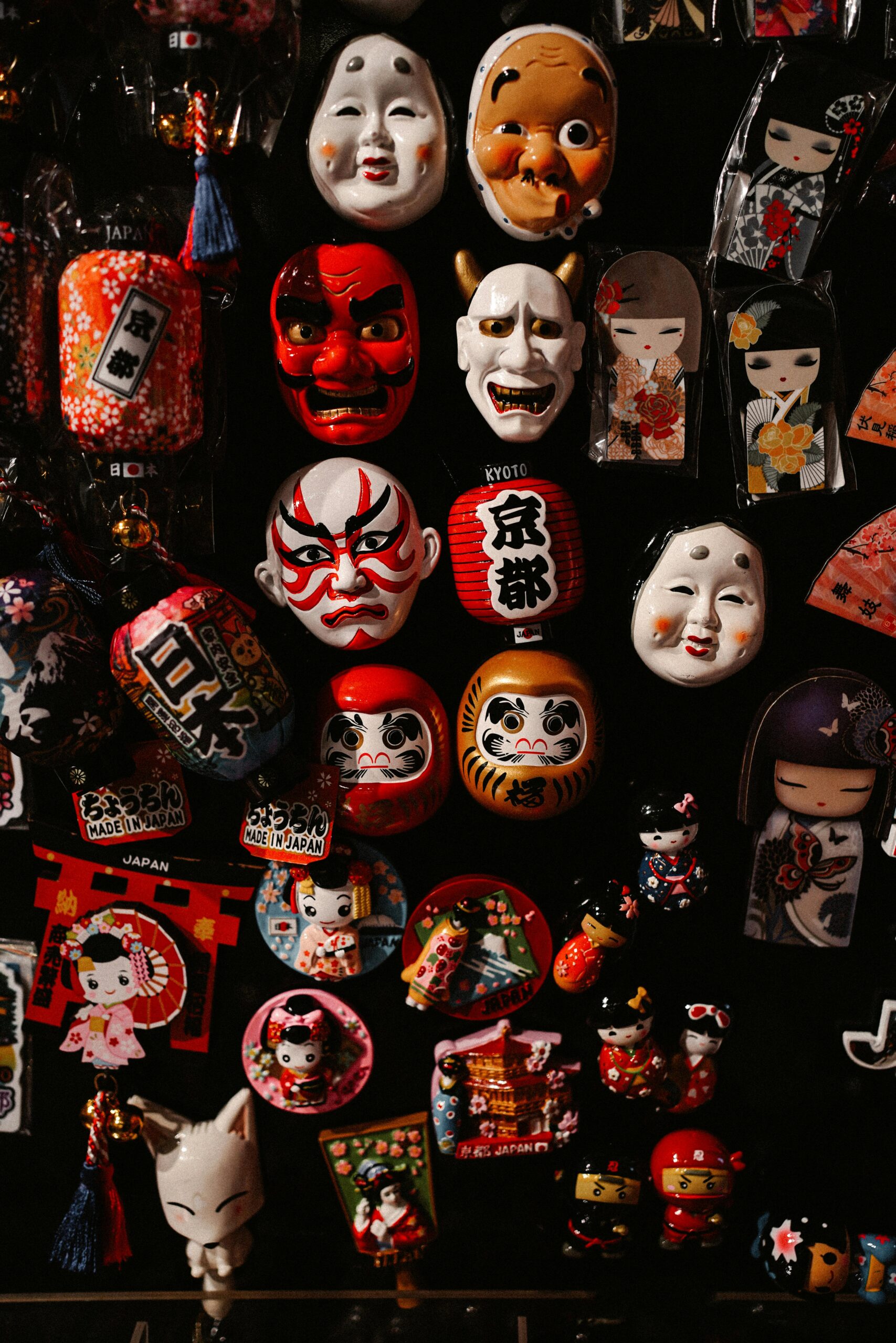 Colorful display of traditional Japanese masks and souvenirs in Kyoto, Japan.